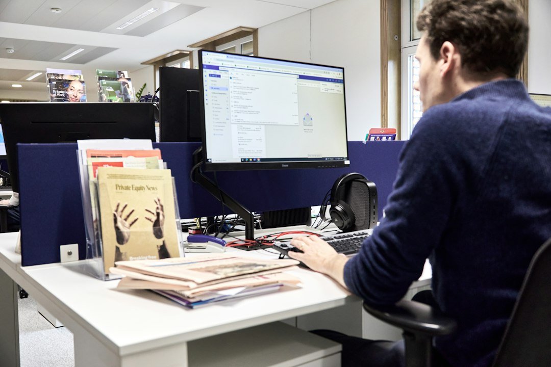 Administrator working at a computer — role-themed stock photograph, not Meridian School