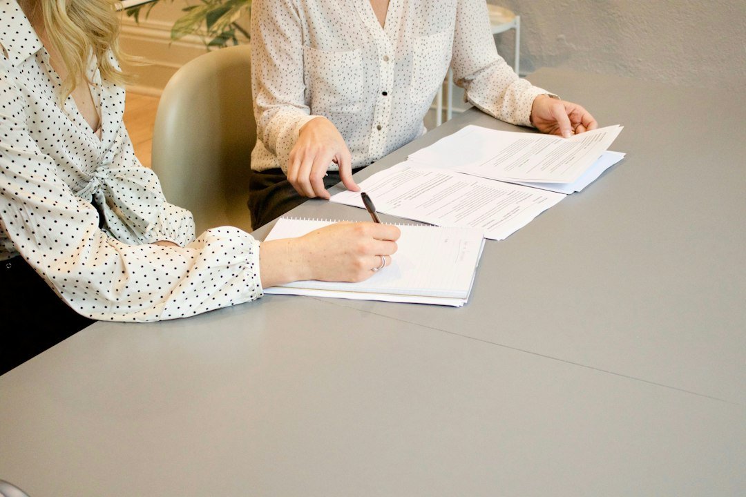 Role-themed stock image of two people reviewing documents for the Childcare Lawyer vacancy in Hove
