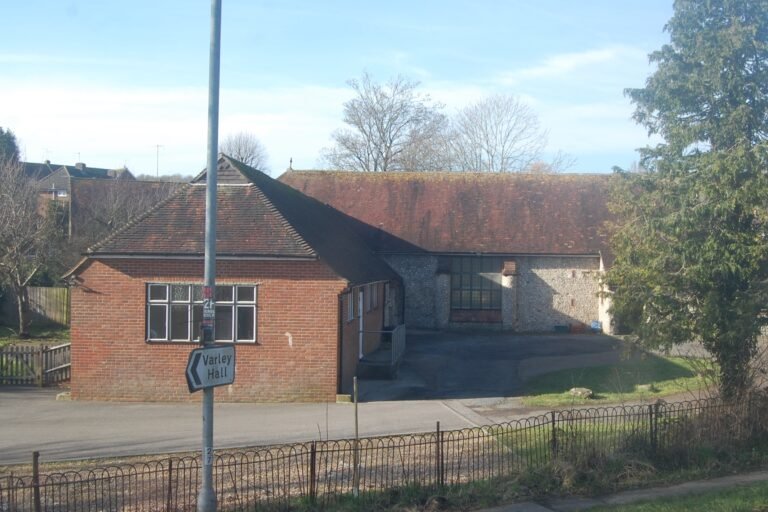 St Mary Magdalene's Church on Coldean Lane, with a Varley Park student accommodation sign in Coldean. Photo: Hassocks5489, CC0.