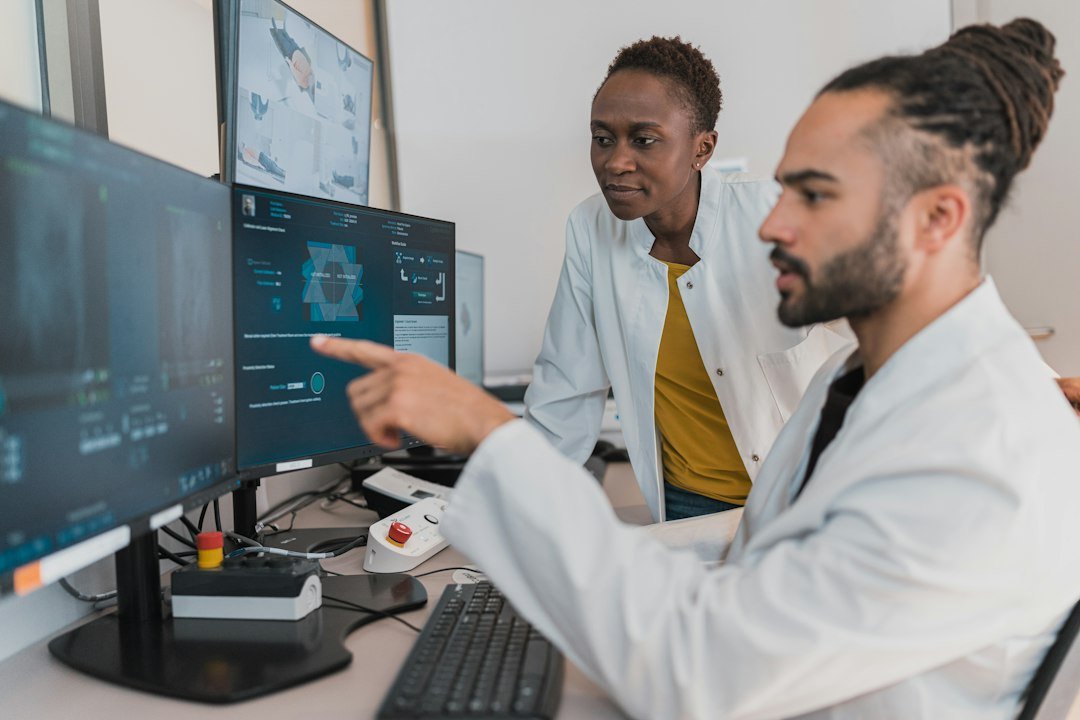 Role-themed stock image of medical professionals reviewing digital data for the NHS Digital Research Access Manager vacancy in Brighton