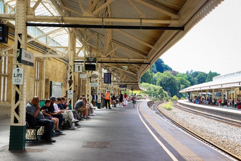 Passengers waiting on a UK railway station platform — illustrative photo by Kamsin Kaneko on Unsplash
