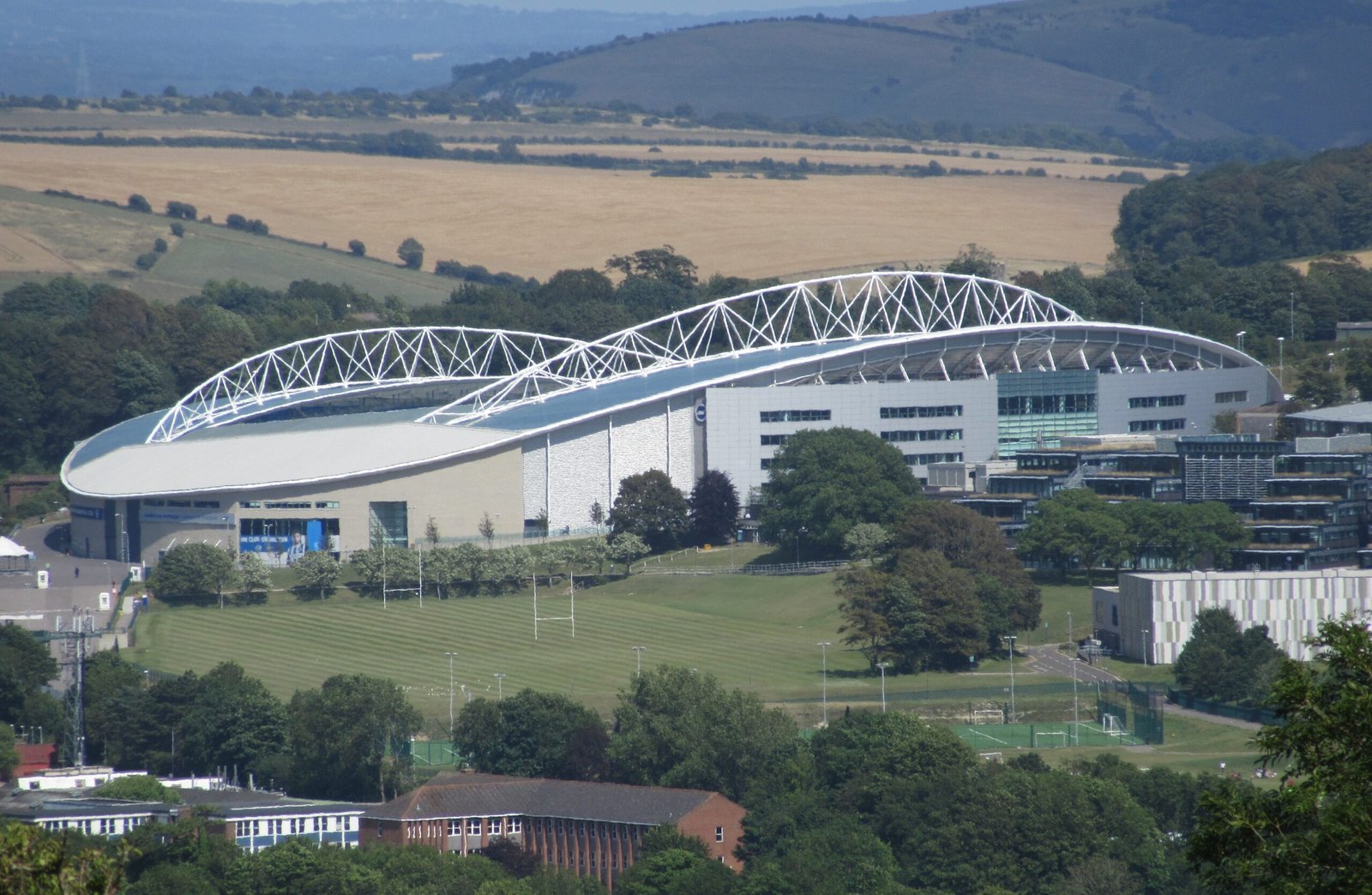 Archive photograph of the Amex Stadium at Falmer, viewed from Hollingbury Hill on 18 July 2015; not a photograph of a 2026 match.